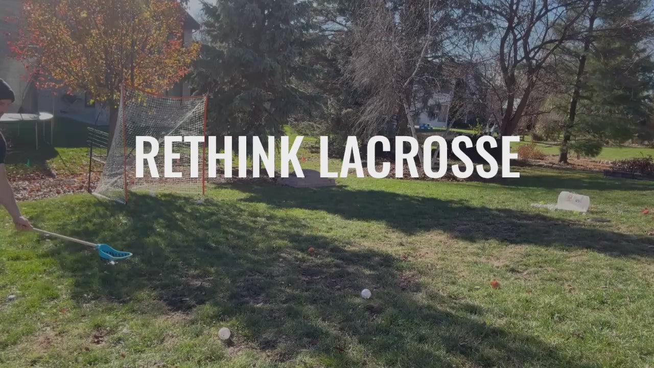 handsome man shoots wiffle balls with the people's lacrosse skill stick into a net in his backyard